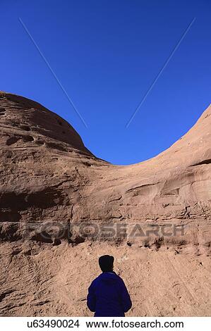 Picture - Silhouette of woman by rock formation in Monument Valley, Arizona, USA. Fotosearch