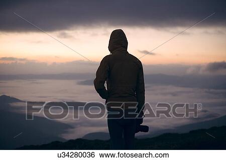 Silhouette of young man with camera at sunset in the Carpathian Mountain Range View Large Photo Image Stock Photograph - Silhouette of young man with camera at sunset in the Carpathian Mountain Range. Fotosearch