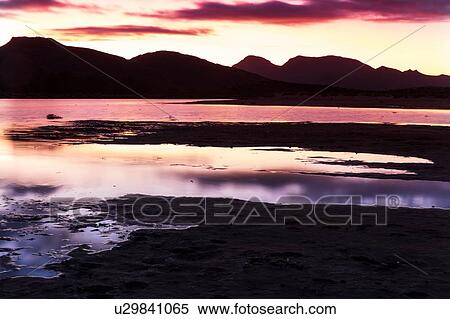 Silhouetted mountain ranges on horizon over water, Cape Town, Western Cape, South Africa View Large Photo Image Stock Photography - Silhouetted mountain ranges on horizon over water, Cape Town, Western Cape, South Africa. Fotosearch