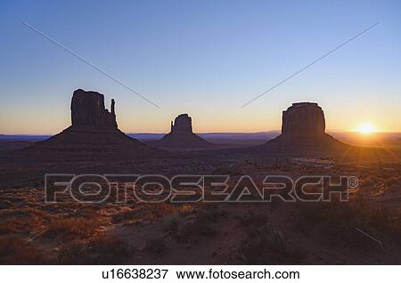 Stock Photo - Silhouettes of rock formations at sunset in Monument Valley, Arizona, USA. Fotosearch