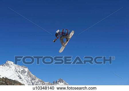 Skier in midair, Saas-Fee, Valais, Switzerland View Large Photo Image Stock Image - Skier in midair, Saas-Fee, Valais, Switzerland. Fotosearch