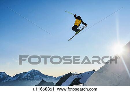 Skier in midair, Saas-Fee, Valais, Switzerland View Large Photo Image Stock Image - Skier in midair, Saas-Fee, Valais, Switzerland. Fotosearch