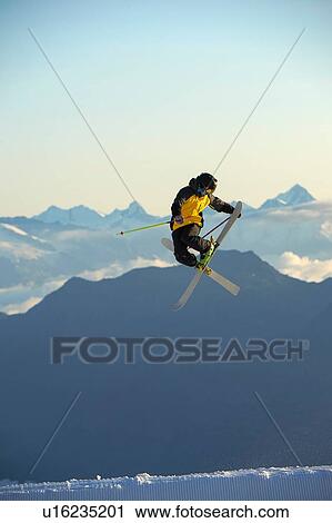 Stock Image - Skier in midair, Saas-Fee, Valais, Switzerland. Fotosearch