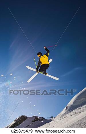 Stock Photo - Skier in midair, Saas-Fee, Valais, Switzerland. Fotosearch