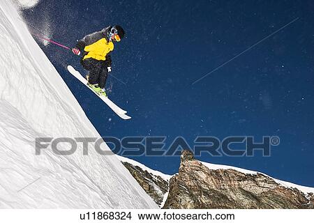 Picture - Skier moving down slopes, Saas-Fee, Valais, Switzerland. Fotosearch