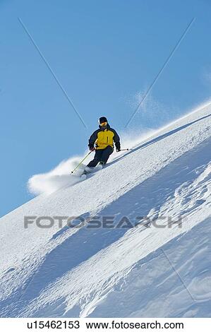 Stock Image - Skier moving down slopes, Saas-Fee, Valais, Switzerland. Fotosearch