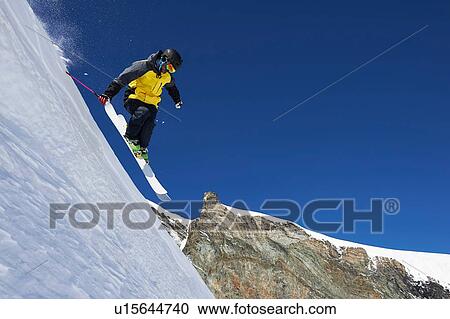 Stock Image - Skier moving down slopes, Saas-Fee, Valais, Switzerland. Fotosearch