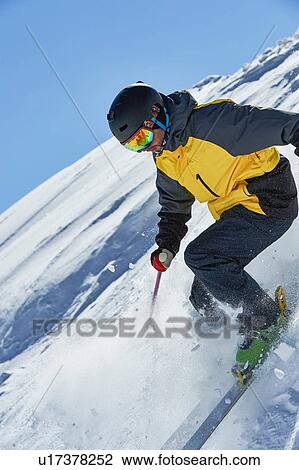 Stock Image - Skier moving down slopes, Saas-Fee, Valais, Switzerland. Fotosearch