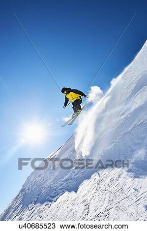 Stock Image - Skier moving down slopes, Saas-Fee, Valais, Switzerland. Fotosearch