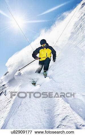 Stock Photo - Skier moving down slopes, Saas-Fee, Valais, Switzerland. Fotosearch