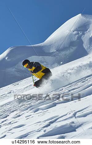 Stock Photograph - Skier moving down slopes, Saas-Fee, Valais, Switzerland. Fotosearch