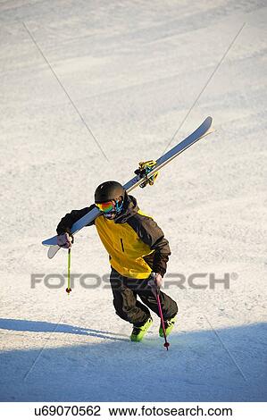 Stock Image - Skier walking up mountain, Saas-Fee, Valais, Switzerland. Fotosearch