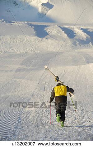 Skier walking up mountain, Saas-Fee, Valais, Switzerland View Large Photo Image Stock Photo - Skier walking up mountain, Saas-Fee, Valais, Switzerland. Fotosearch