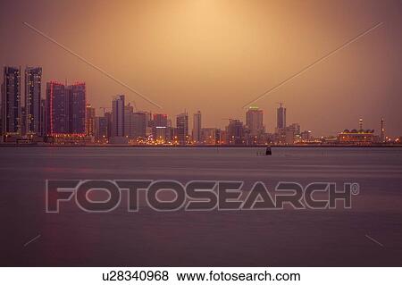 Stock Photo - Skyline at sunset in Manama, Bahrain. Fotosearch