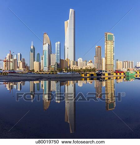 Stock Image - Skyline reflected in sea in Kuwait City, Kuwait. Fotosearch
