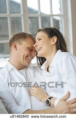 Smiling couple embracing View Large Photo Image Stock Photography - Smiling couple embracing. Fotosearch