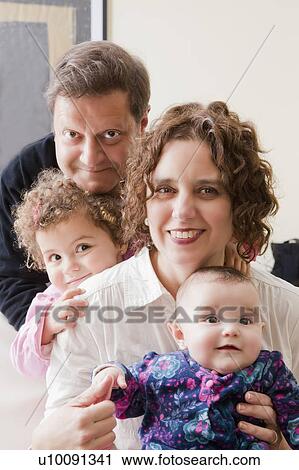 Smiling family with two children View Large Photo Image Stock Image - Smiling family with two children. Fotosearch