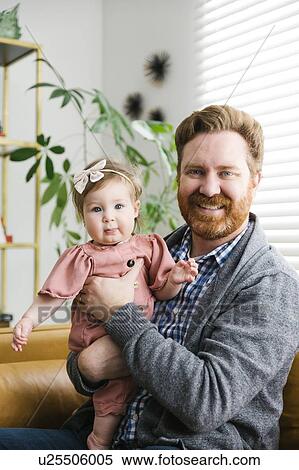 Smiling father holding his baby girl View Large Photo Image Stock Photography - Smiling father holding his baby girl. Fotosearch
