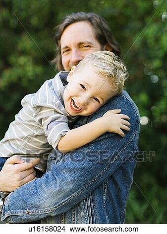 Picture - Smiling father holding his son. Fotosearch