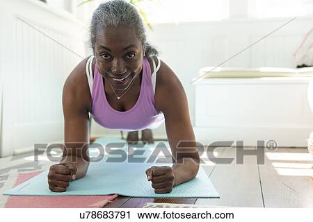 Smiling mature woman doing yoga View Large Photo Image Stock Image - Smiling mature woman doing yoga. Fotosearch