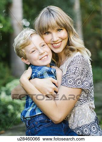 Stock Photograph - Smiling mother and son embracing. Fotosearch