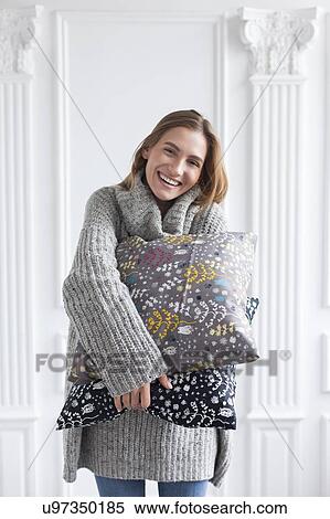 Smiling woman holding patterned cushions View Large Photo Image Stock Photography - Smiling woman holding patterned cushions. Fotosearch