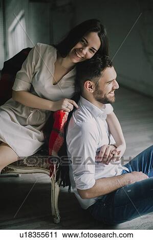 Smiling young couple with sofa View Large Photo Image Stock Image - Smiling young couple with sofa. Fotosearch
