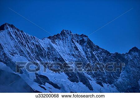 Snow capped mountain ridge, Saas-Fee, Valais, Switzerland View Large Photo Image Stock Photo - Snow capped mountain ridge, Saas-Fee, Valais, Switzerland. Fotosearch