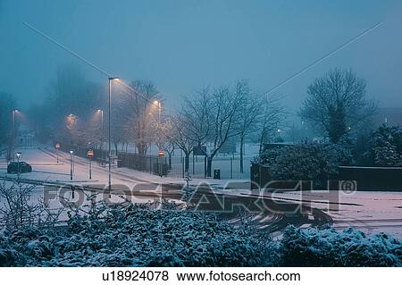 Stock Photo - Snow-covered street and park, Manchester, UK. Fotosearch