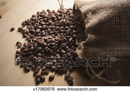 Stock Photo - Spilled sack of roasted coffee beans. Fotosearch