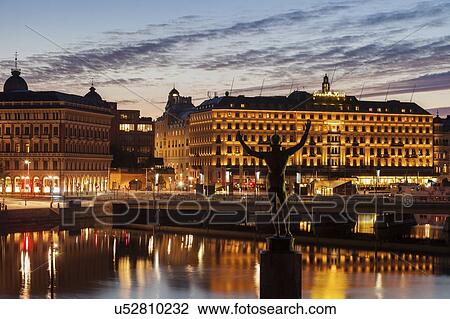 Statue by buildings at sunset in Stockholm, Sweden View Large Photo Image Stock Image - Statue by buildings at sunset in Stockholm, Sweden. Fotosearch
