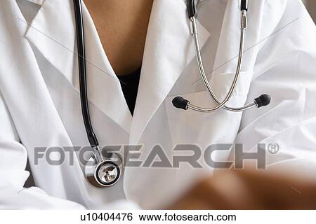 Stethoscope around doctor's neck View Large Photo Image Stock Photograph - Stethoscope around doctor's neck. Fotosearch