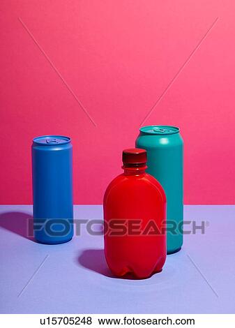 Still life of turquoise and blue drink cans with red bottle and pink background View Large Photo Image Stock Photo - Still life of turquoise and blue drink cans with red bottle and pink background. Fotosearch