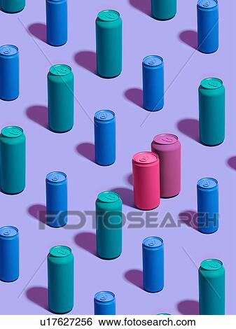 Stock Photograph - Still life of turquoise and blue drink cans in diagonal rows, with pink and purple drink cans standing out from the crowd on purple background. Fotosearch
