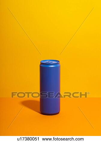 Stock Image - Still life with purple drink can and yellow background. Fotosearch