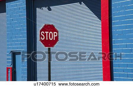 Stop sign by blue garage door View Large Photo Image Stock Photography - Stop sign by blue garage door. Fotosearch