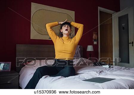 Stock Photograph - Stressed woman on bed. Fotosearch