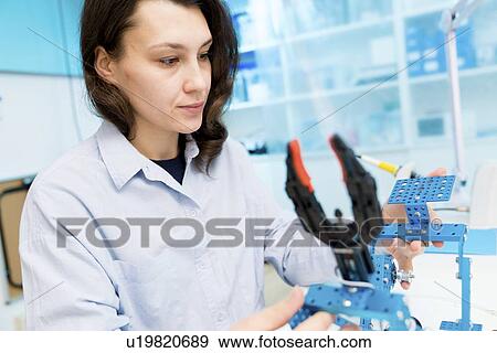 Stock Photo - Student in CNC (computer numerical control) and robotics laboratory, experiment with microcontroller and robot CNC module.. Fotosearch