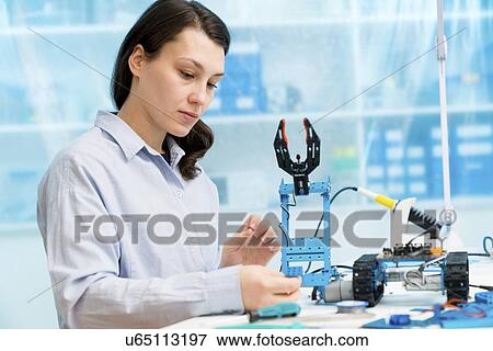 Student in CNC (computer numerical control) and robotics laboratory, experiment with microcontroller and robot CNC module. View Large Photo Image Stock Photo - Student in CNC (computer numerical control) and robotics laboratory, experiment with microcontroller and robot CNC module.. Fotosearch
