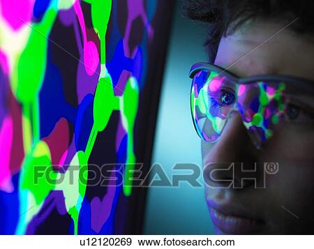 Stock Photo - Student understanding the design of a molecular structure on computer screen in laboratory. Fotosearch