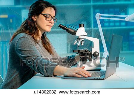 Student using microscope. View Large Photo Image Stock Image - Student using microscope.. Fotosearch