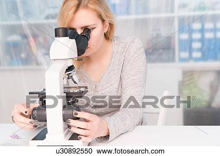 Student using microscope. View Large Photo Image Stock Image - Student using microscope.. Fotosearch