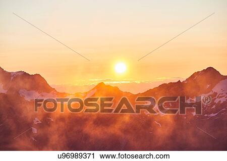Sun glowing on horizon over mountain range, Saas-Fee, Valais, Switzerland View Large Photo Image Stock Image - Sun glowing on horizon over mountain range, Saas-Fee, Valais, Switzerland. Fotosearch
