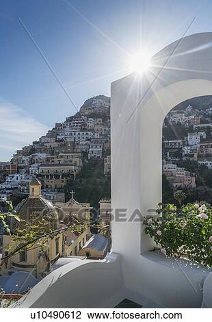 Stock Image - Sunbeam over whitewash arch in Positano on Amalfi Coast, Italy. Fotosearch