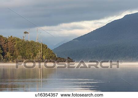 Stock Photo - Sunrise on Te Anau Lake, New Zealand. Fotosearch