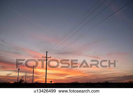 Sunset over highway lined with telephone poles View Large Photo Image Stock Photo - Sunset over highway lined with telephone poles. Fotosearch
