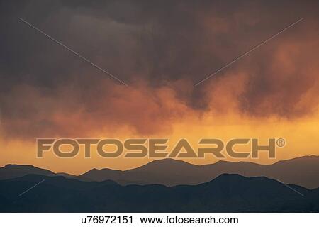 Stock Image - Sunset over mountains in the Front Range, Denver, Colorado. Fotosearch