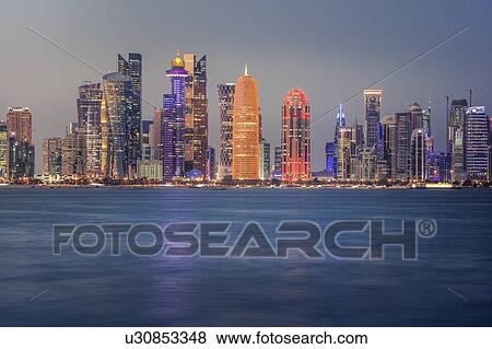 Stock Photo - Sunset skyline of Doha, Qatar. Fotosearch