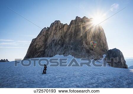 Stock Image - Sunshine above rock formation in Bugaboo Provincial Park, British Columbia, Canada. Fotosearch