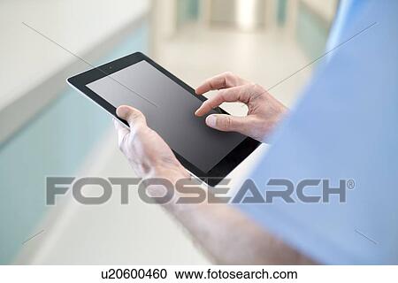 Surgeon using digital tablet, close up. View Large Photo Image Stock Image - Surgeon using digital tablet, close up.. Fotosearch
